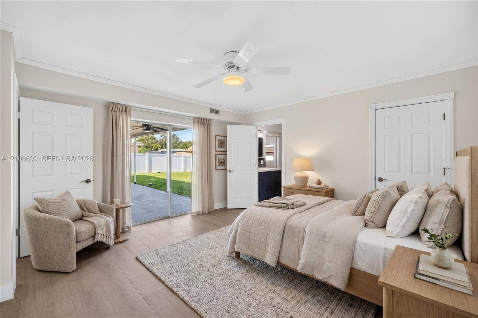 9121 SW 54th Place, Cooper City, FL 33328 Primary bedroom w/ walk in closet w/ built-ins, en suite bathroom leading to backyard w/ new plank wood look tile