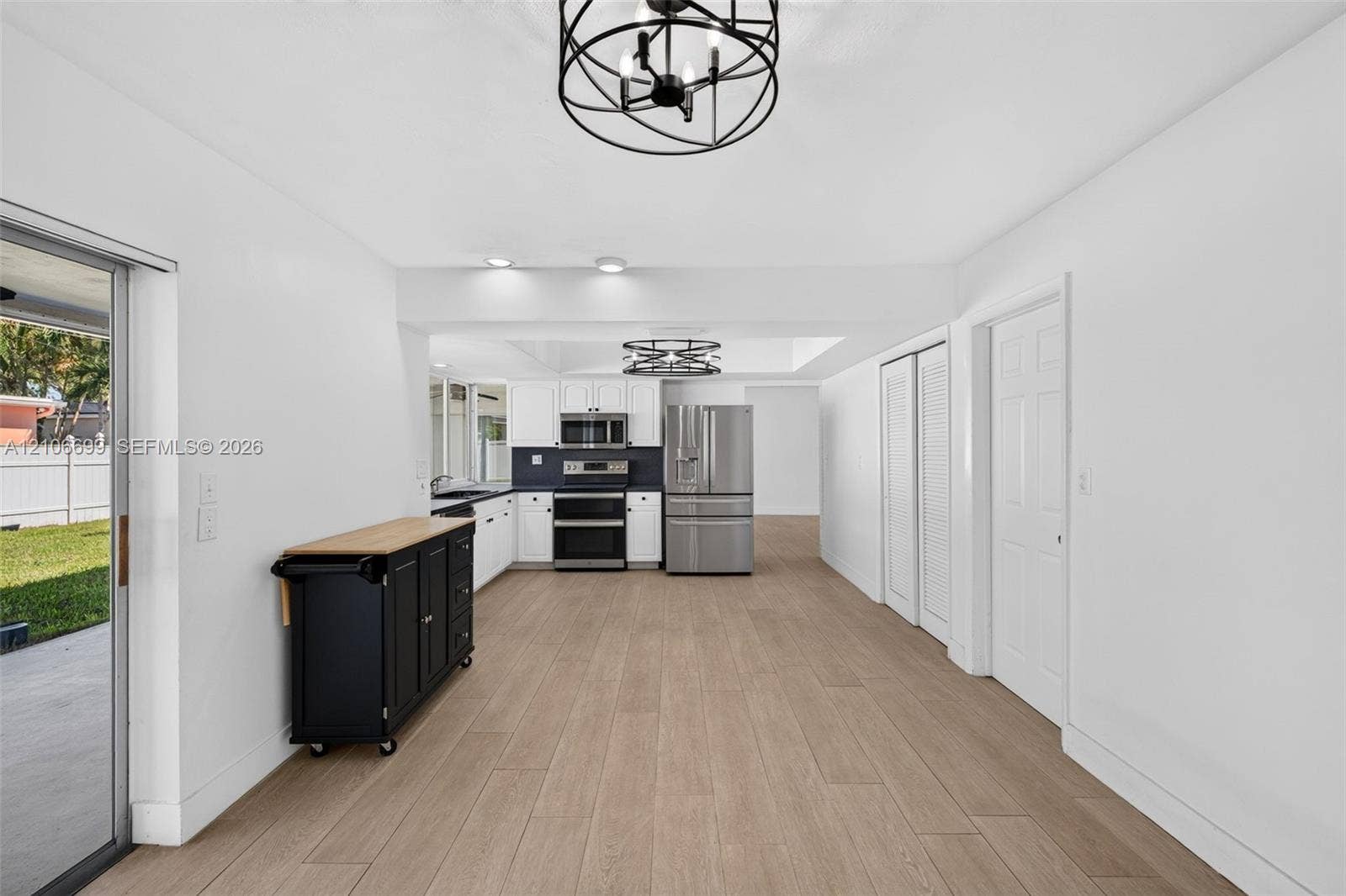 9121 SW 54th Place, Cooper City, FL 33328 Open concept kitchen w/ updated plank wood look tile, stainless appliances approx 2020