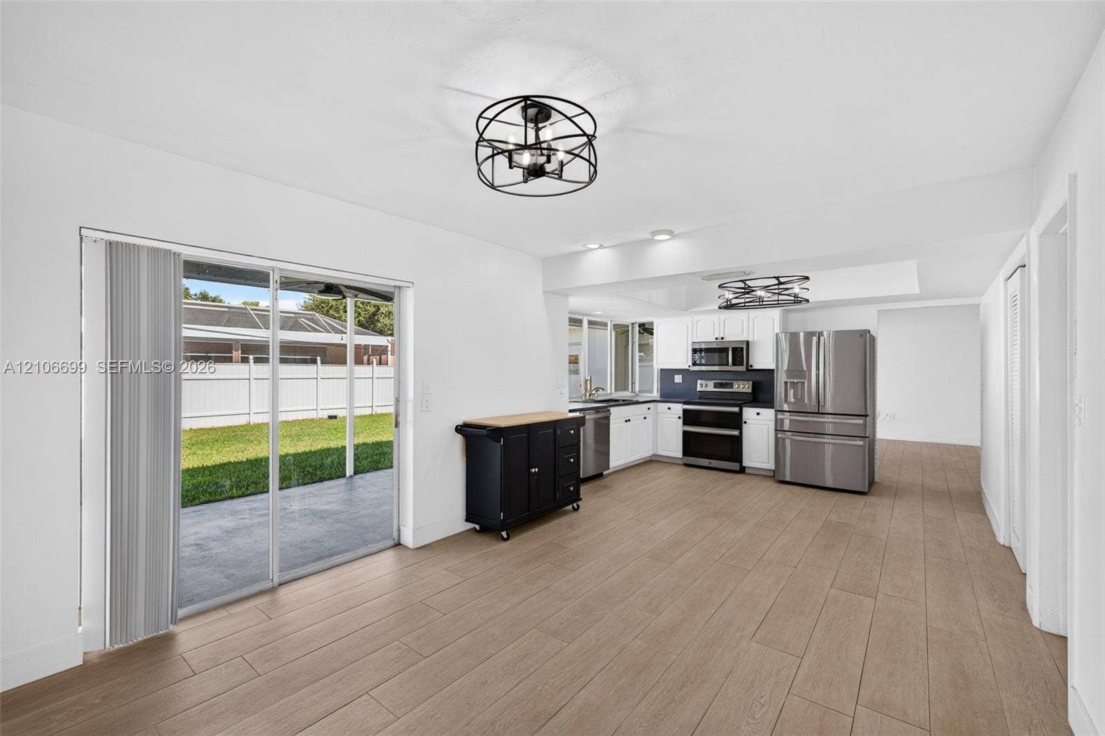 9121 SW 54th Place, Cooper City, FL 33328 Open concept kitchen w/ updated plank wood look tile, stainless appliances approx 2020