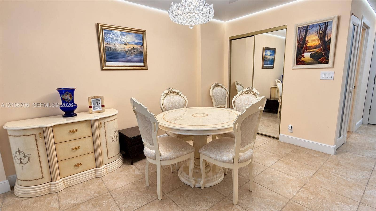 Ceramic tile flooring, recessed ceiling lighting, a decorative crystal chandelier, and mirrored closet doors