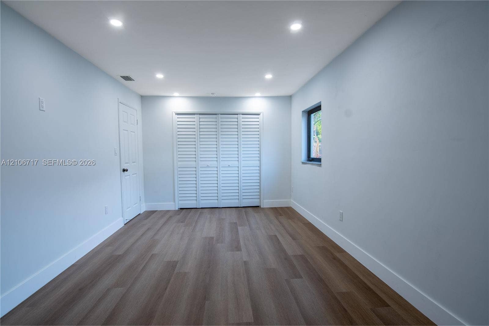 6811 Thomas Street, Hollywood, FL 33024 Interior space featuring wood-finish flooring, recessed lighting, and white louvered closet doors