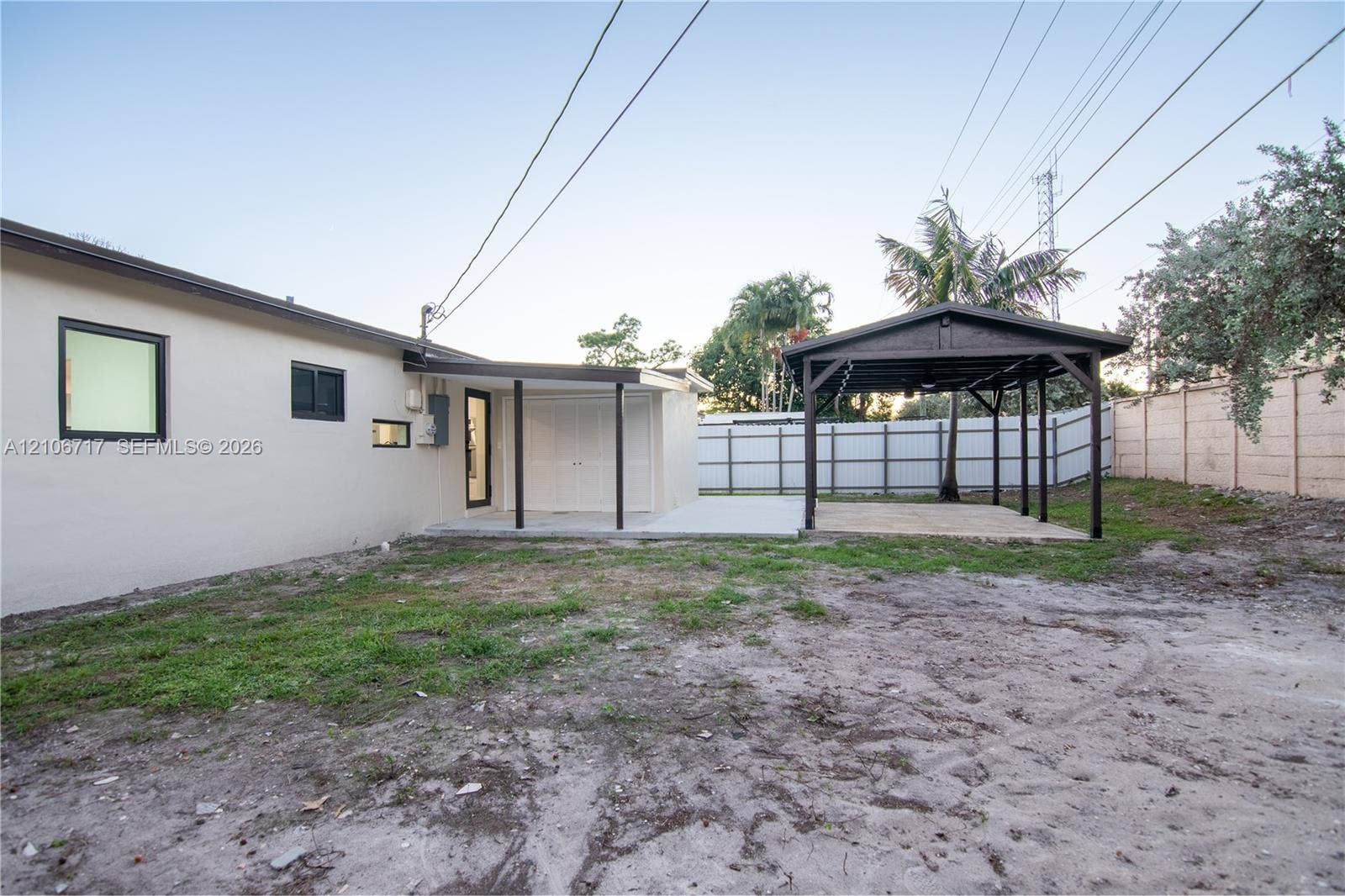 6811 Thomas Street, Hollywood, FL 33024 Backyard featuring a covered patio, a detached timber-framed pavilion, and a solid perimeter wall