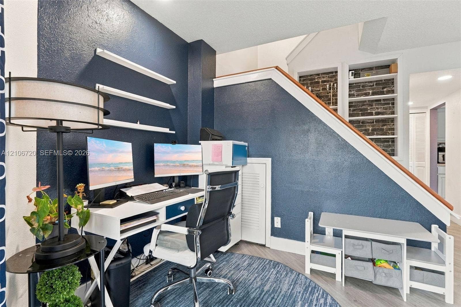 152 Weybridge Circle, #C, Royal Palm Beach, FL 33411 Built-in shelving, exposed brick detail, and wood-finish flooring