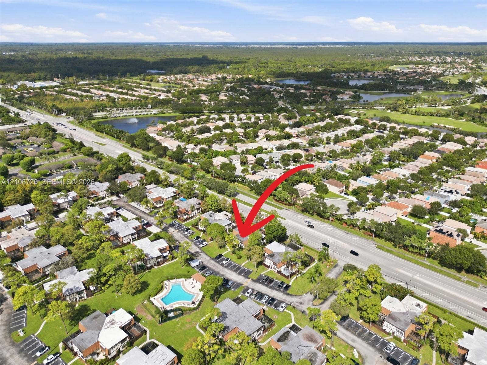 152 Weybridge Circle, #C, Royal Palm Beach, FL 33411 Aerial perspective of a multi-unit residential community featuring mature landscaping and a centrally located outdoor swimming pool