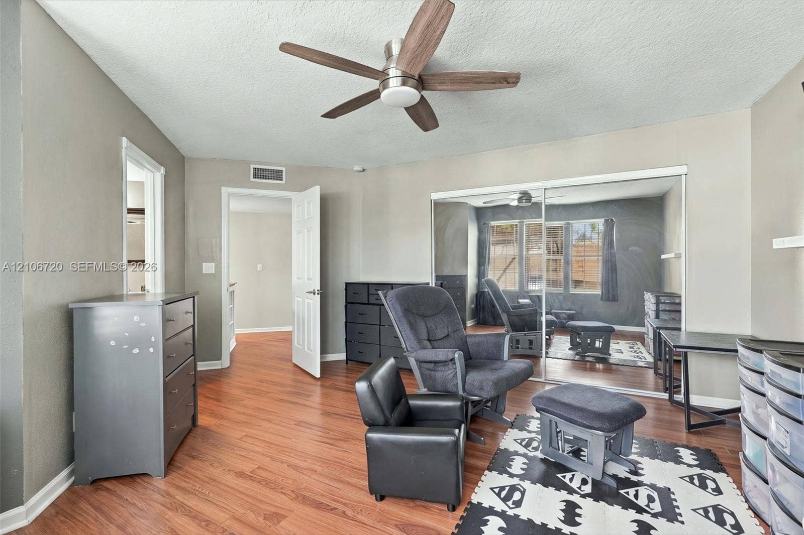 152 Weybridge Circle, #C, Royal Palm Beach, FL 33411 Wood-finish flooring, ceiling fan with integrated lighting, and wall-to-wall sliding mirrored closet doors