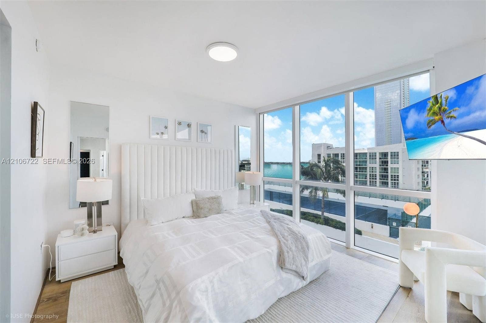 480 NE 30th Street, #1005, Miami, FL 33137 Floor-to-ceiling windows featuring expansive exterior scenery, neutral walls, and wood-finish flooring