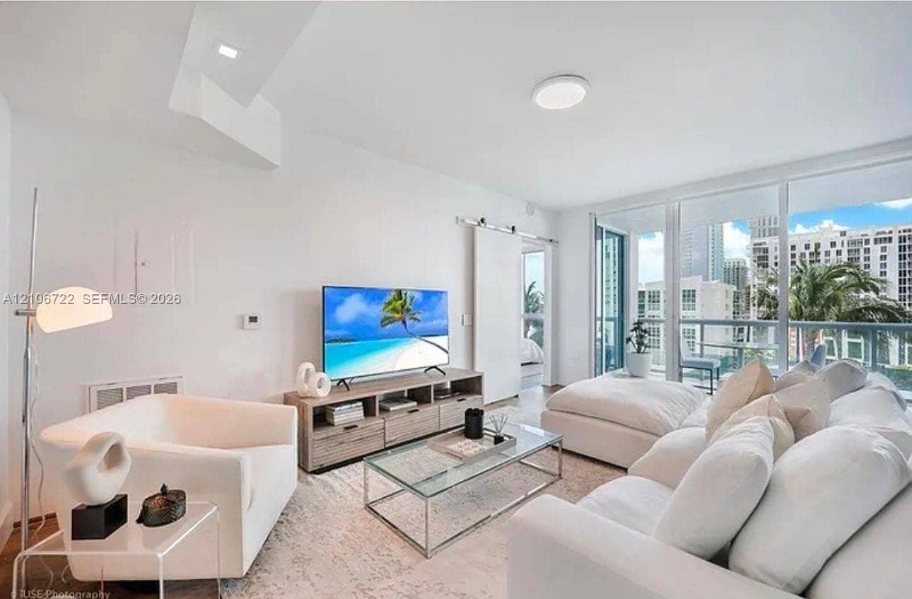 480 NE 30th Street, #1005, Miami, FL 33137 Floor-to-ceiling glass wall, sliding barn door, and recessed lighting