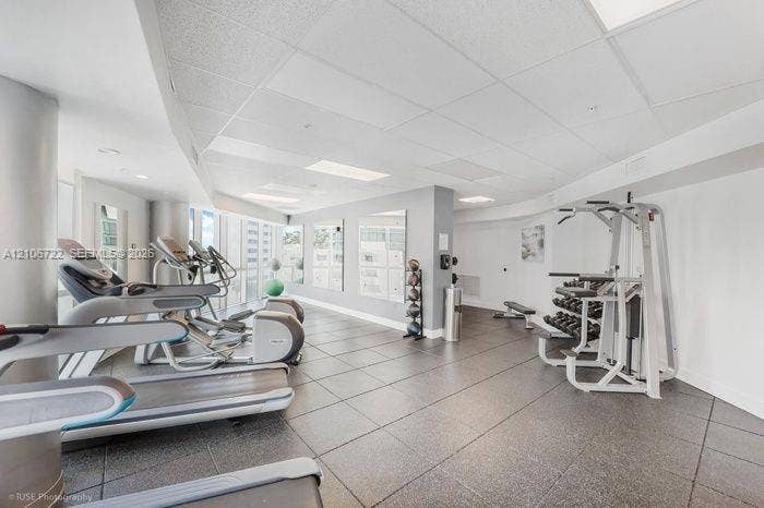 480 NE 30th Street, #1005, Miami, FL 33137 Fitness center featuring square tile flooring, recessed lighting, and wall-mounted mirrors