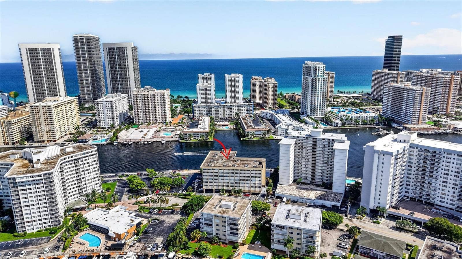 111 Golden Isles Drive, #G12, Hallandale Beach, FL 33009 Aerial perspective of the coastal cityscape featuring high-rise buildings, waterway access, and proximity to the oceanfront