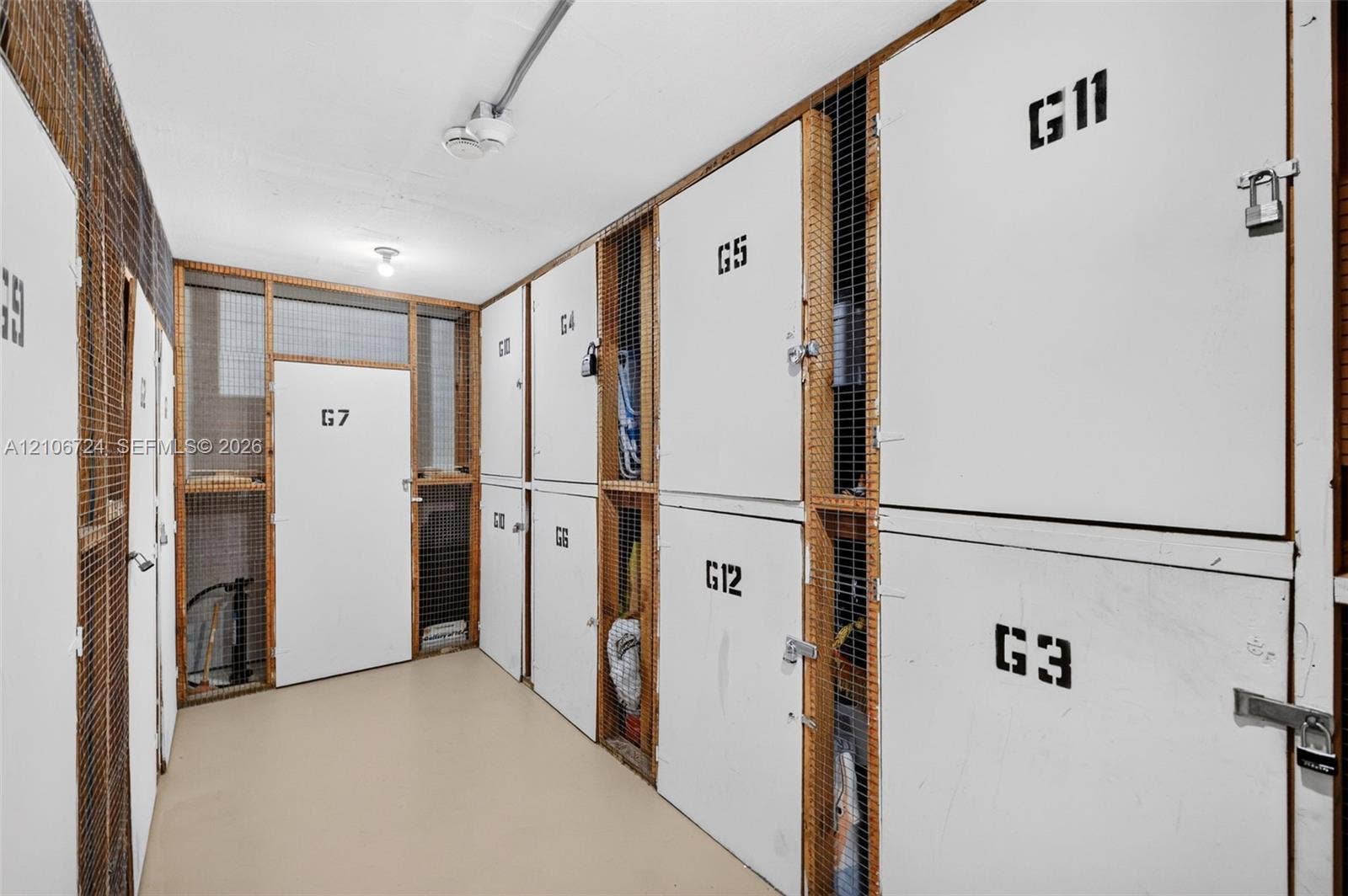 111 Golden Isles Drive, #G12, Hallandale Beach, FL 33009 Dedicated storage area featuring numbered, secure lockers with mesh wire paneling and metal door hardware