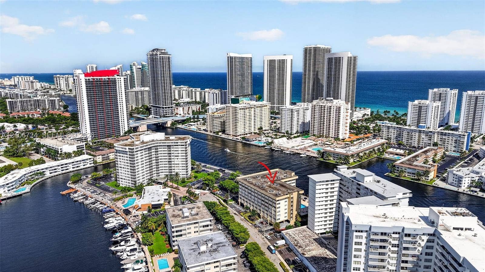 111 Golden Isles Drive, #G12, Hallandale Beach, FL 33009 Multi-story building positioned along a waterway with proximity to coastal shorelines and high-density urban infrastructure