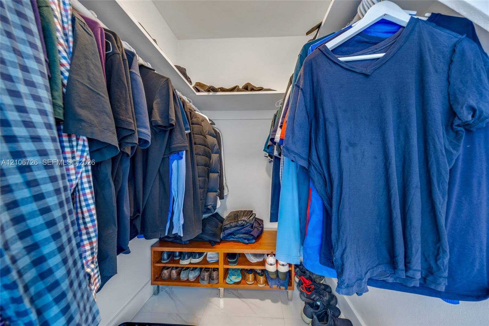 1200 West Avenue, #606, Miami Beach, Miami Beach, FL 33139 Walk-in closet featuring tiered shelving, built-in wooden storage unit, and polished tile flooring