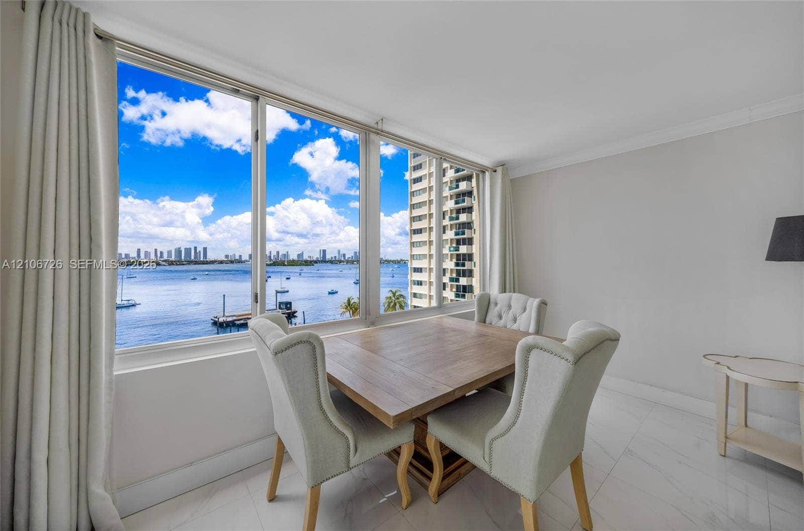 1200 West Avenue, #606, Miami Beach, Miami Beach, FL 33139 Large floor-to-ceiling windows, polished tile flooring, and expansive water and skyline scenery
