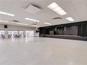 1000 SW 11 Avenue, #12, Hallandale Beach, Hallandale Beach, FL 33009 Expansive open-concept space featuring polished concrete flooring, suspended drop ceiling, recessed lighting, and a raised stage with built-in curtains