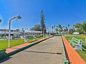 1000 SW 11 Avenue, #12, Hallandale Beach, Hallandale Beach, FL 33009 Bocce ball court featuring a crushed stone playing surface, perimeter framing, overhead lighting, and surrounding bench seating