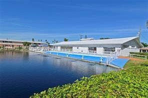 1000 SW 11 Avenue, #12, Hallandale Beach, Hallandale Beach, FL 33009 Waterfront swimming pool featuring a concrete deck and metal perimeter fencing