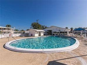 1000 SW 11 Avenue, #12, Hallandale Beach, Hallandale Beach, FL 33009 Curved in-ground swimming pool featuring a white concrete surround and a metal ladder entry