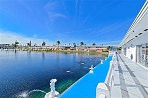 1000 SW 11 Avenue, #12, Hallandale Beach, Hallandale Beach, FL 33009 Waterfront exterior featuring a tiled patio, decorative fountains, and stone balustrade railings