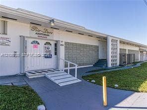 1000 SW 11 Avenue, #12, Hallandale Beach, Hallandale Beach, FL 33009 Single-story commercial building exterior featuring a wide access ramp, decorative concrete screen block wall, covered entryway, and painted concrete walkways