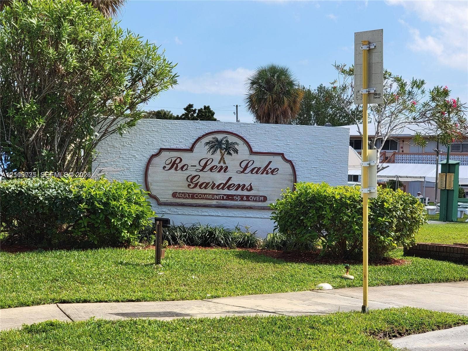 1000 SW 11 Avenue, #12, Hallandale Beach, Hallandale Beach, FL 33009 Community entrance sign featuring textured masonry walls, manicured landscaping, and mature palm trees