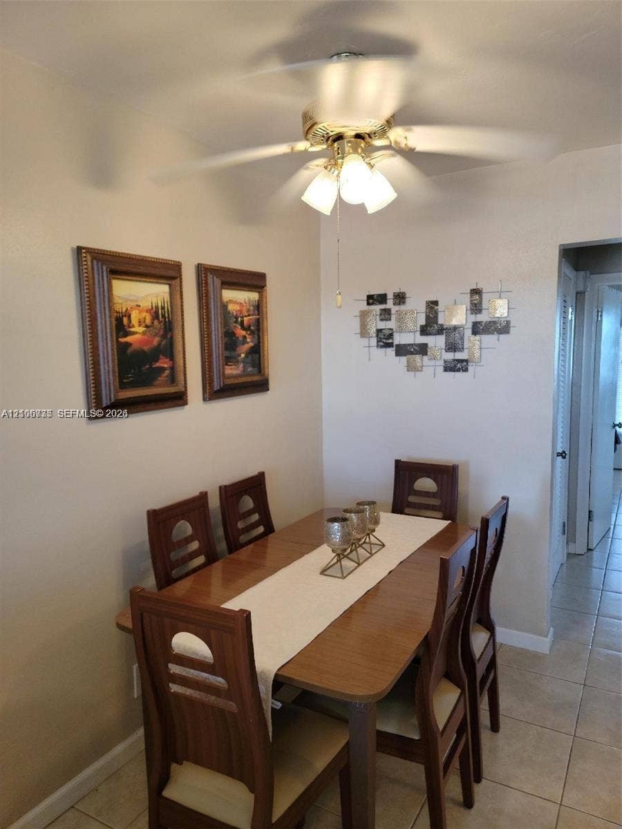1000 SW 11 Avenue, #12, Hallandale Beach, Hallandale Beach, FL 33009 Ceiling-mounted fan with three-light fixture and neutral tile flooring