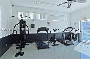 1000 SW 11 Avenue, #12, Hallandale Beach, Hallandale Beach, FL 33009 Room featuring high-contrast two-tone walls, clerestory windows, ceiling fan with integrated lighting, track lighting, and a glass sliding door