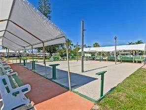 1000 SW 11 Avenue, #12, Hallandale Beach, Hallandale Beach, FL 33009 Recreational area featuring concrete shuffleboard courts, covered seating structures, and permanent bench installations