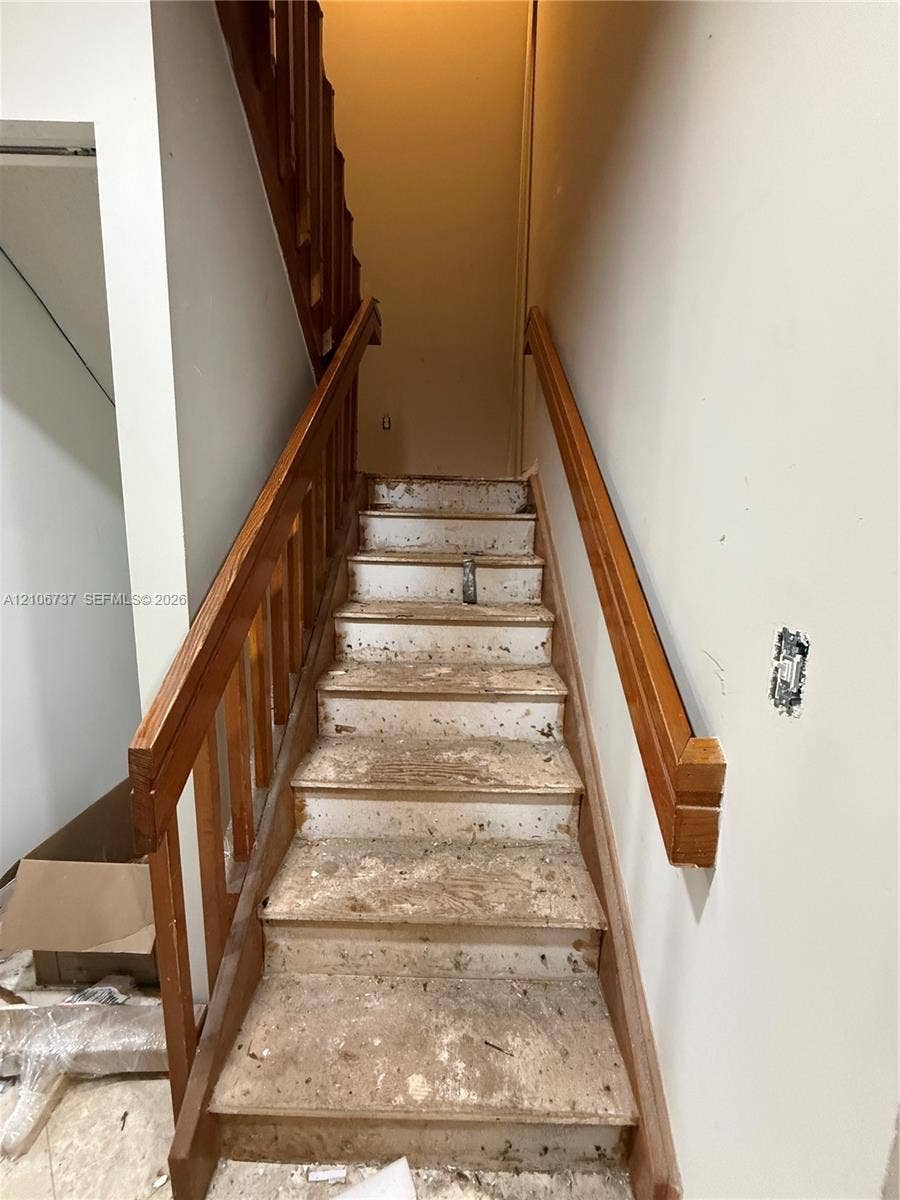 5225 Monterey Circle, #G, Delray Beach, FL 33484 Staircase featuring wood handrails and balusters