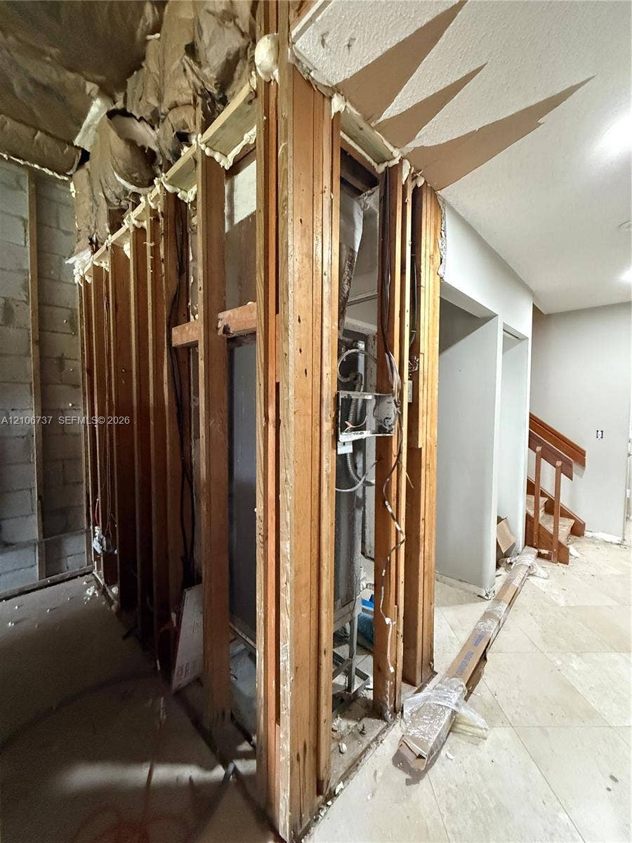 5225 Monterey Circle, #G, Delray Beach, FL 33484 Exposed wood stud framing with visible insulation, concrete block wall segments, and tile flooring