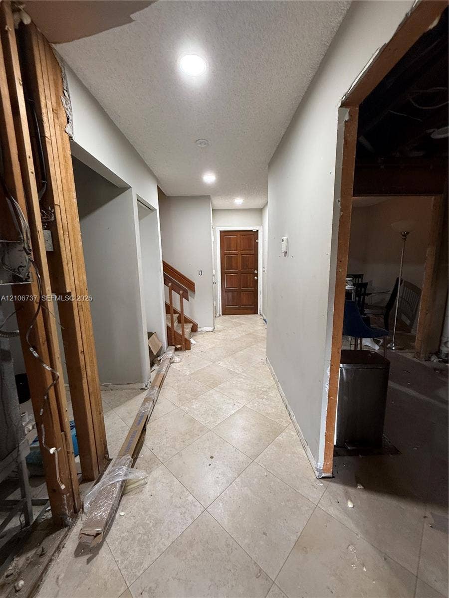 5225 Monterey Circle, #G, Delray Beach, FL 33484 Interior entry featuring tile flooring, recessed lighting, and a paneled wooden front door