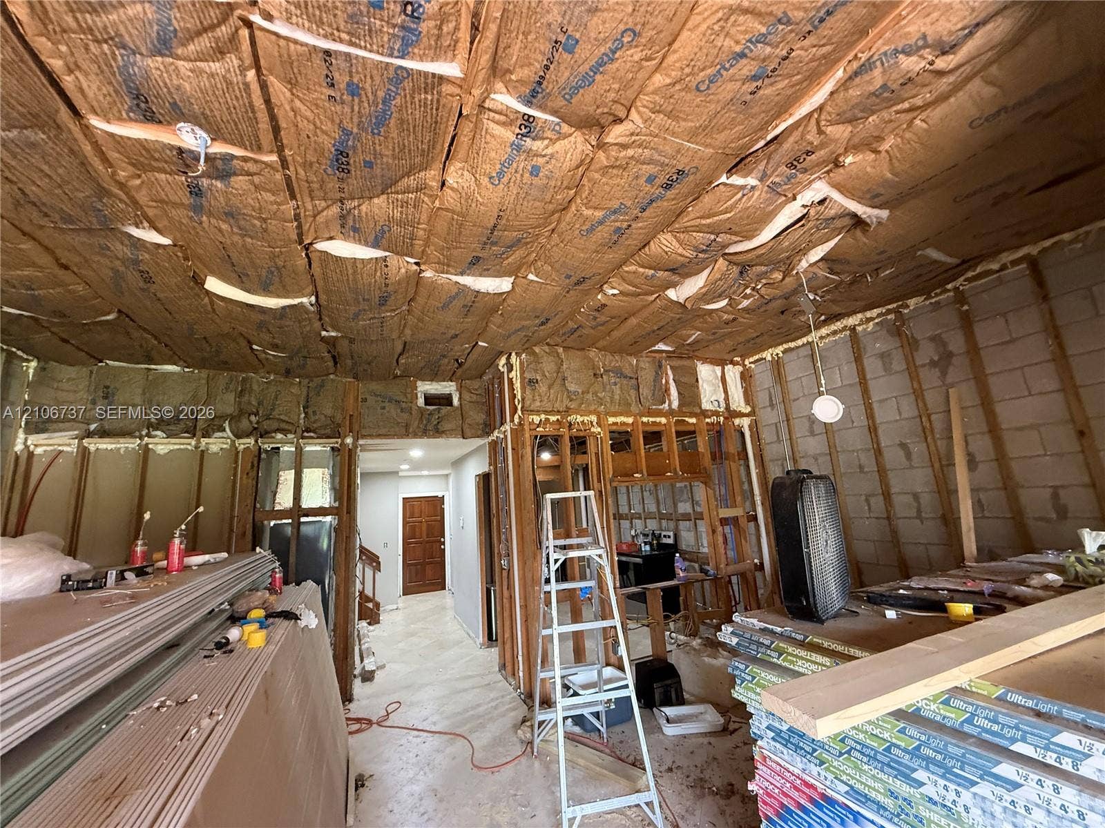 5225 Monterey Circle, #G, Delray Beach, FL 33484 Exposed structural framing featuring concrete block masonry, wood stud wall construction, and ceiling-installed batt insulation