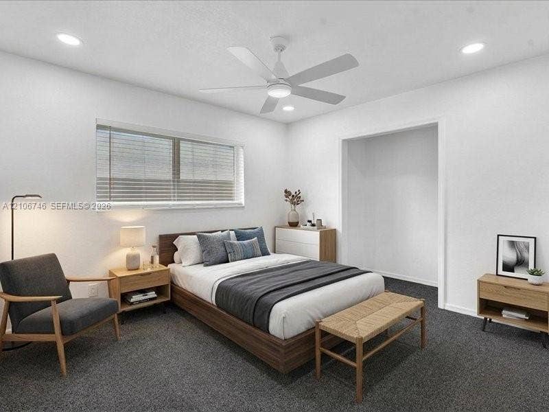 Neutral-toned interior featuring recessed lighting, a modern white ceiling fan, and wall-to-wall carpeting