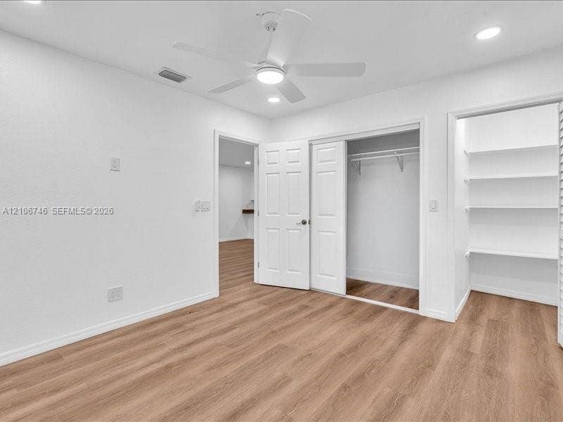 6608 SW 49th Street, #0, Davie, Davie, FL 33314 Wood-finish flooring, recessed lighting, ceiling fan with integrated light, closet with double doors, and built-in shelving