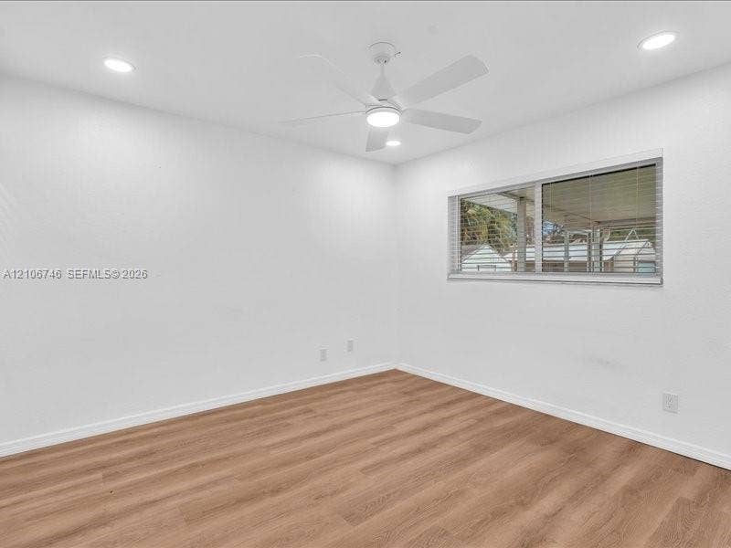 6608 SW 49th Street, #0, Davie, Davie, FL 33314 Interior space featuring wood-finish flooring, white walls, recessed ceiling lighting, and a white ceiling fan with integrated lighting