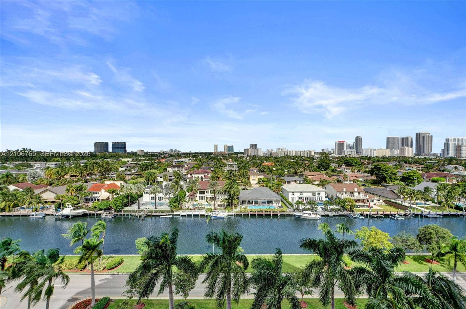 3598 Yacht Club Drive, #901, Aventura, FL 33180 Panoramic views, a deep-water canal, private residential boat docks, and palm trees.