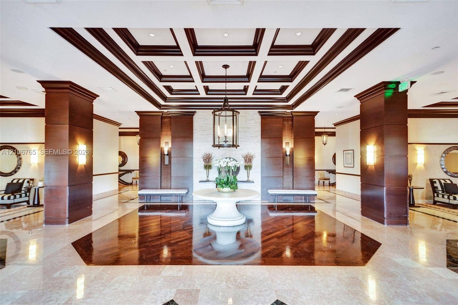 3598 Yacht Club Drive, #901, Aventura, FL 33180 Grand entrance hall, offered ceiling with wood detailing, natural stone flooring with a dark wood-finish inlay, large wood-panelled columns, custom hanging lantern lighting, and a stacked stone accent wall.