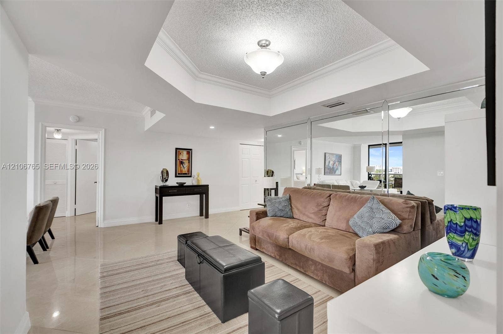 3598 Yacht Club Drive, #901, Aventura, FL 33180 Dining room used as a den, octagonal tray ceiling with recessed lighting and neutral wall finishes, mirrored wall.
