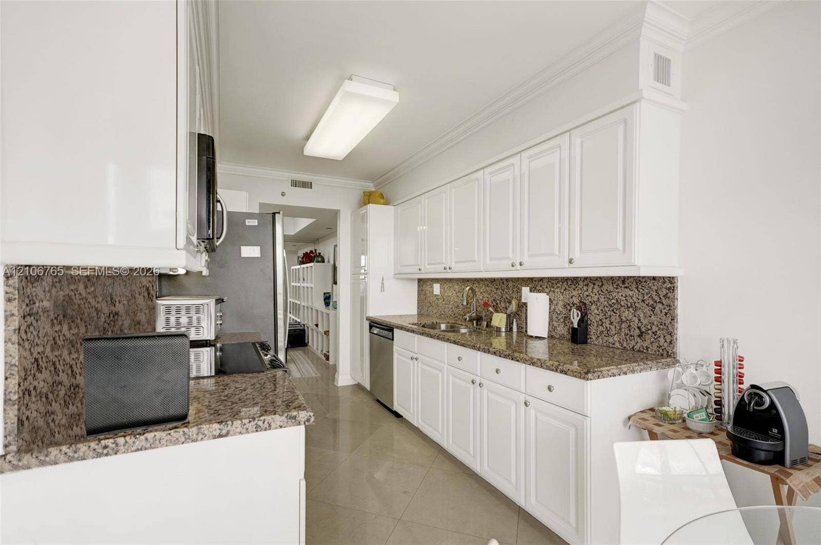 3598 Yacht Club Drive, #901, Aventura, FL 33180 White cabinetry, stone-finish countertops, integrated stainless steel appliances.