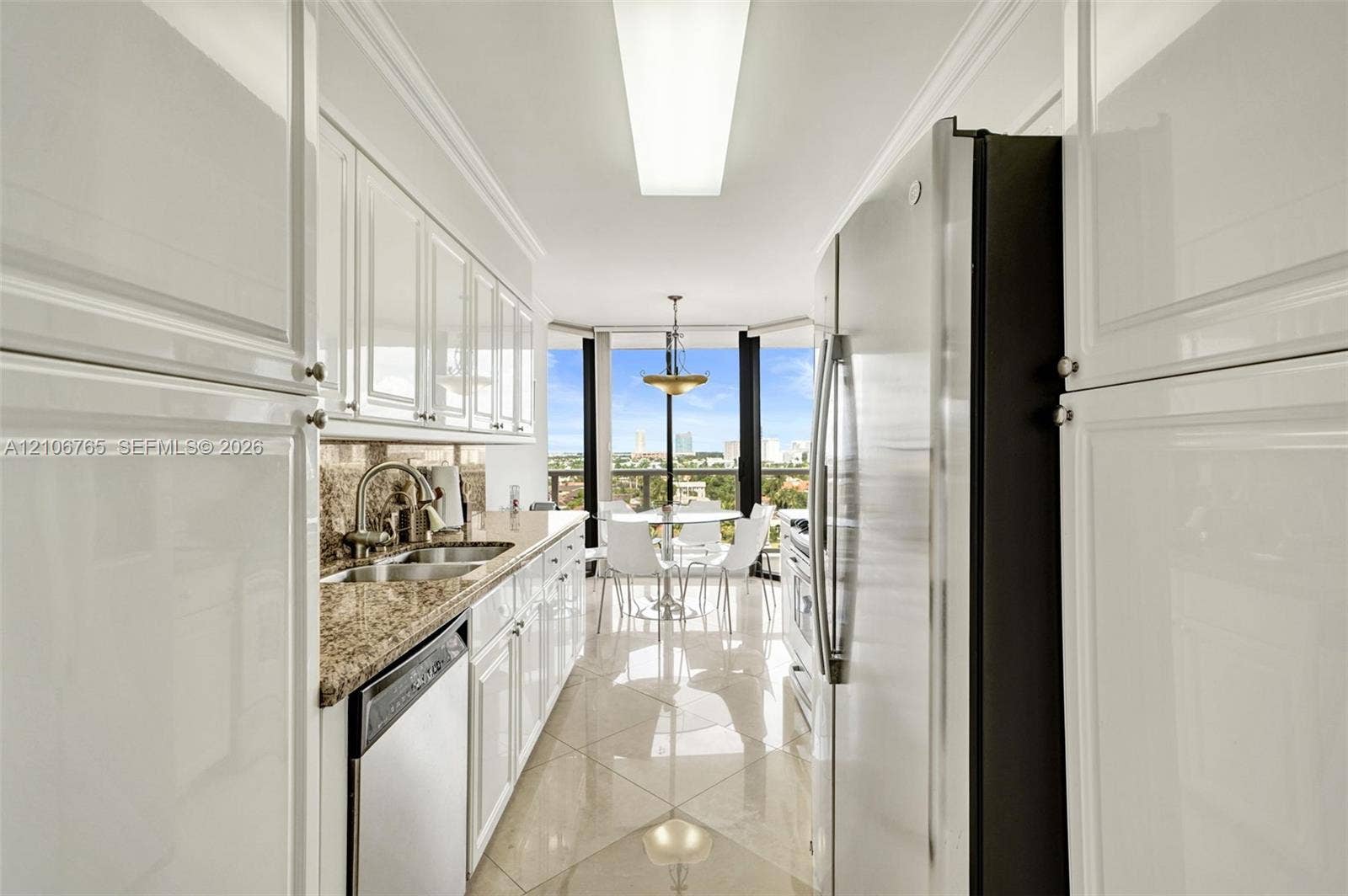3598 Yacht Club Drive, #901, Aventura, FL 33180 Kitchen with white cabinetry, stone countertops, stainless steel appliances, and ceramic floors.