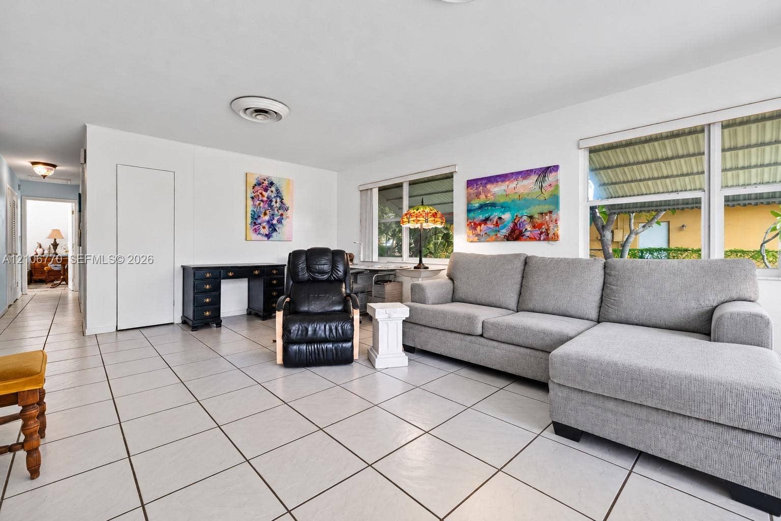 5701 SW 1st Street, Plantation, FL 33317 Neutral ceramic tile flooring, clean white wall finishes, and large windows providing natural light