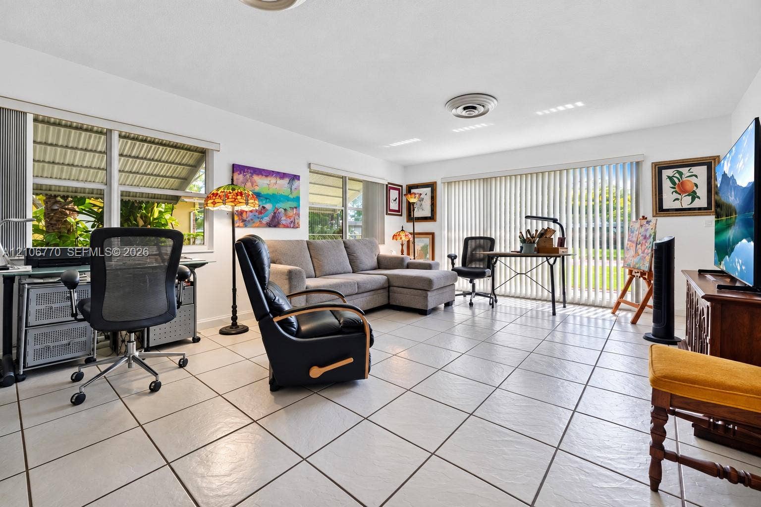 5701 SW 1st Street, Plantation, FL 33317 Neutral ceramic tile flooring, large-format windows, and sliding glass doors featuring vertical blinds