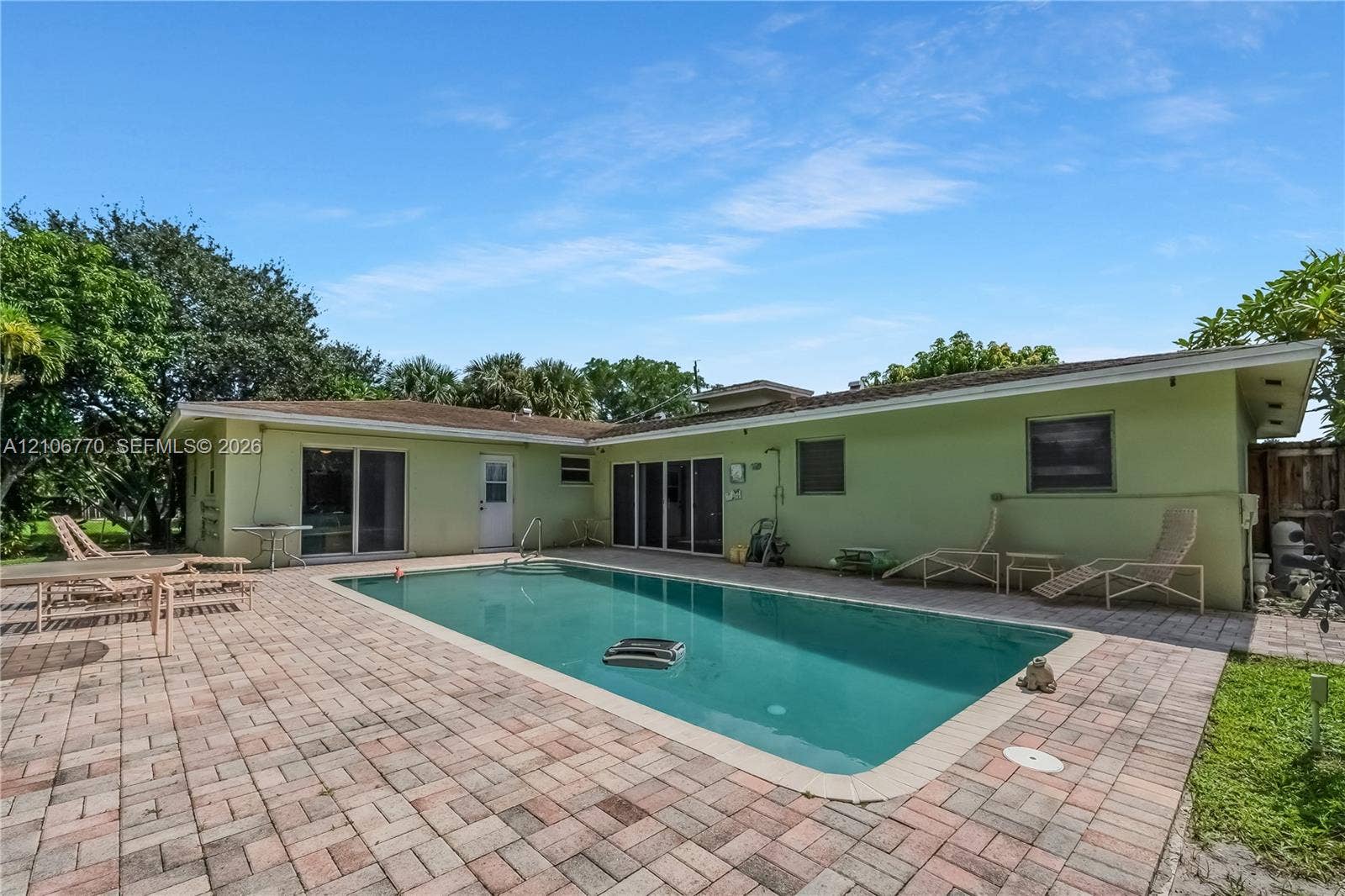 5701 SW 1st Street, Plantation, FL 33317 In-ground swimming pool with a concrete surround, paver patio, and sliding glass door access