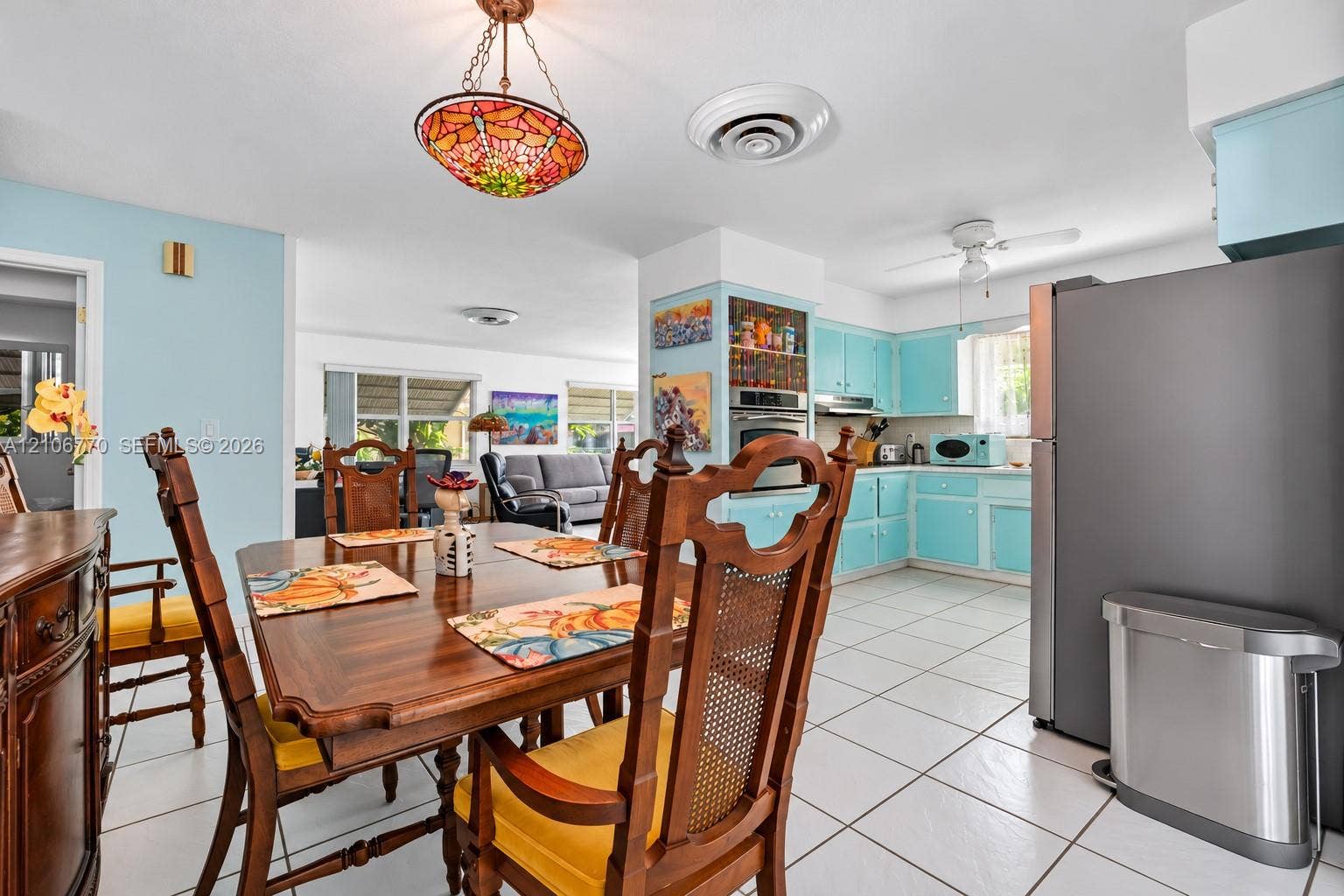 5701 SW 1st Street, Plantation, FL 33317 Kitchen featuring light blue cabinetry, tile flooring, built-in wall oven, and a decorative stained-glass pendant light fixture