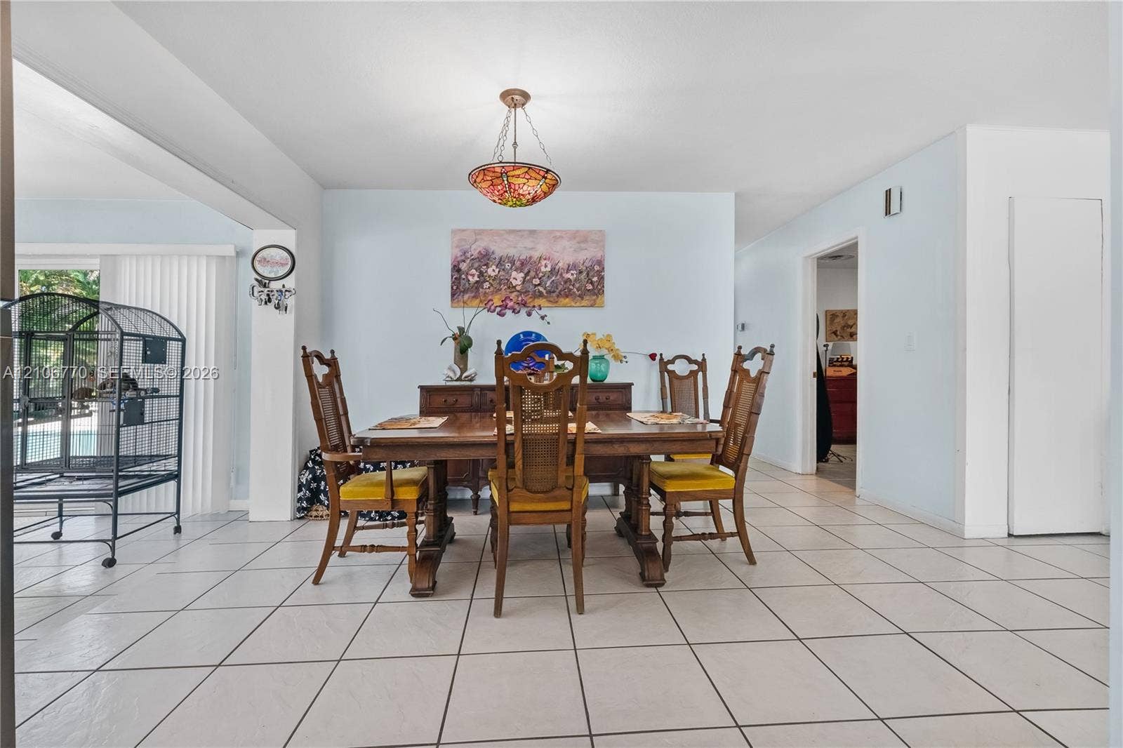 5701 SW 1st Street, Plantation, FL 33317 Dining area featuring tile flooring and a decorative stained-glass pendant light fixture