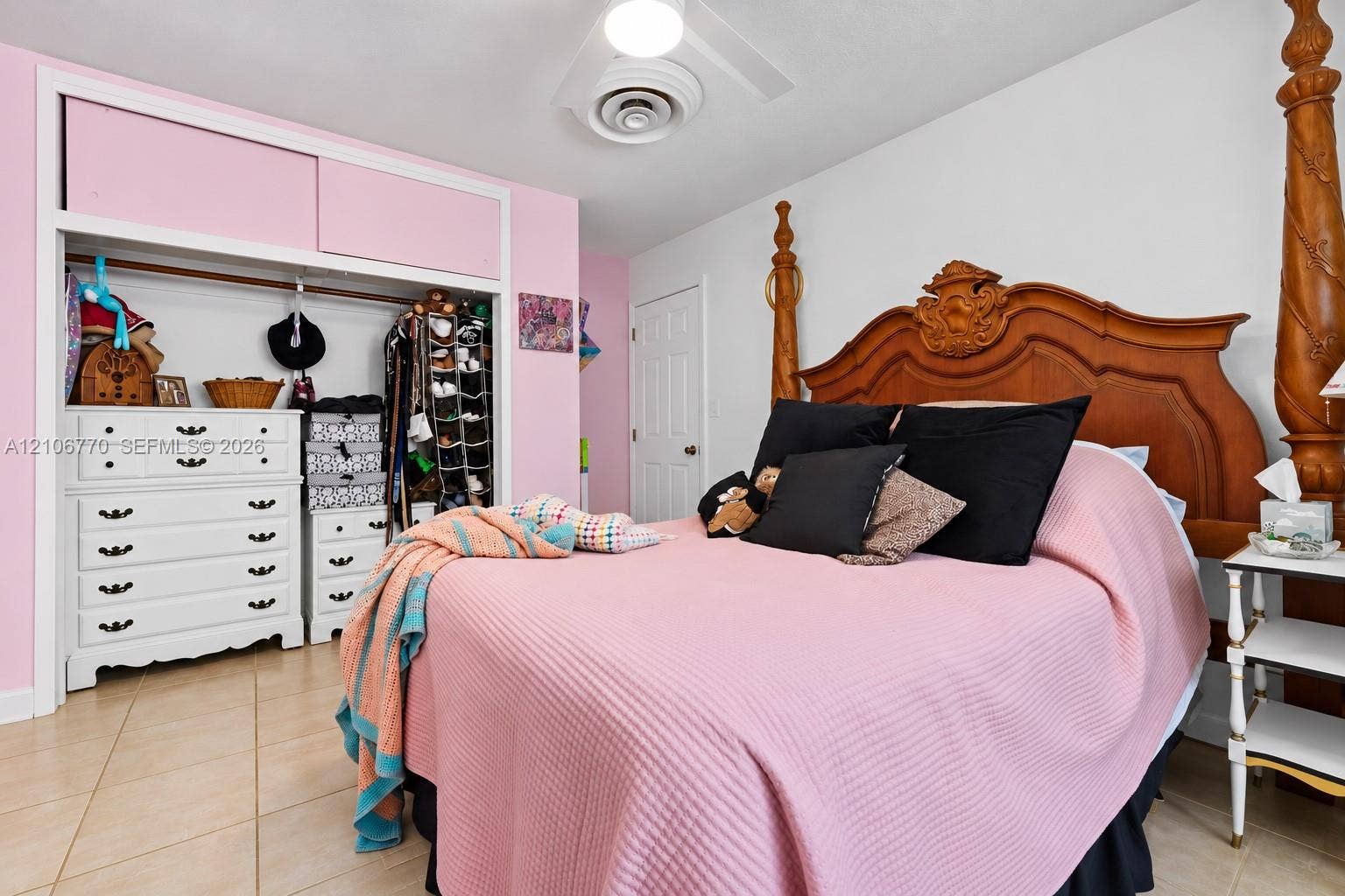 5701 SW 1st Street, Plantation, FL 33317 Bedroom featuring tile flooring, sliding door closet with integrated upper storage cabinets, and a central ceiling light fixture
