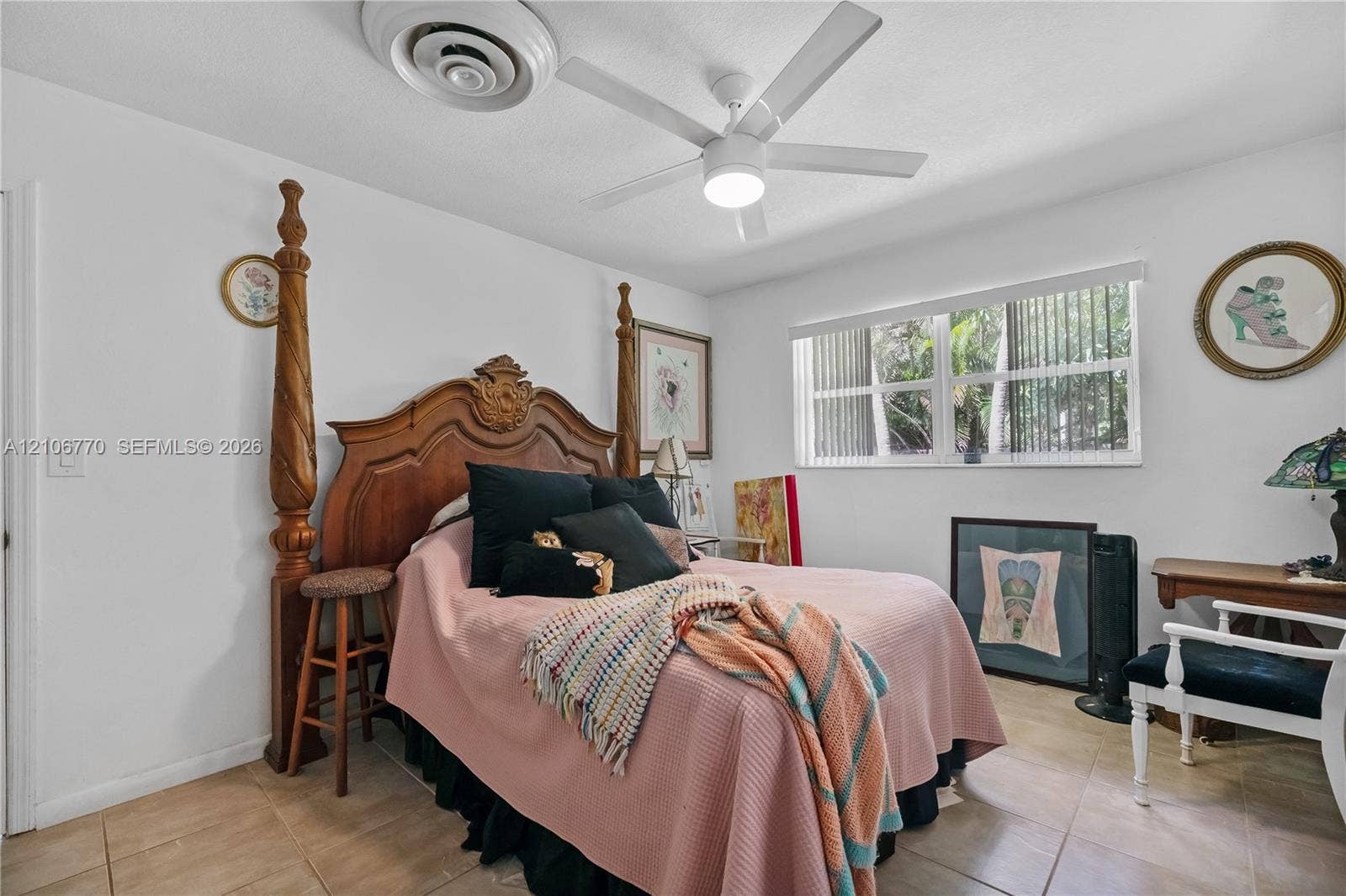 5701 SW 1st Street, Plantation, FL 33317 Neutral-toned tile flooring, large-format window, and a multi-blade ceiling fan with integrated lighting