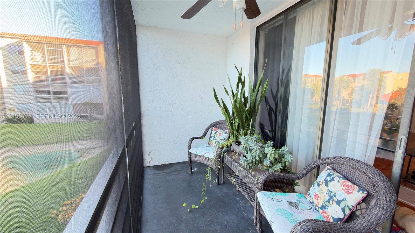 1810 SW 81st Avenue, #2200, North Lauderdale, North Lauderdale, FL 33068 Screened-in balcony featuring a concrete floor, ceiling fan, and sliding glass door