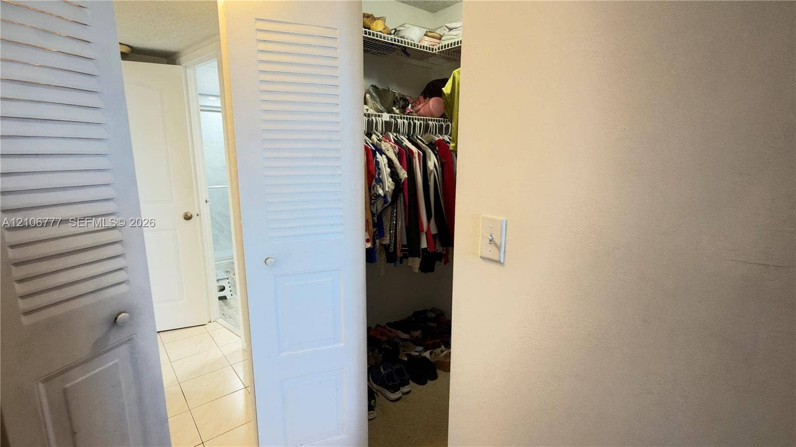 1810 SW 81st Avenue, #2200, North Lauderdale, North Lauderdale, FL 33068 Storage area featuring louvered bi-fold doors, built-in wire shelving, and tiled flooring