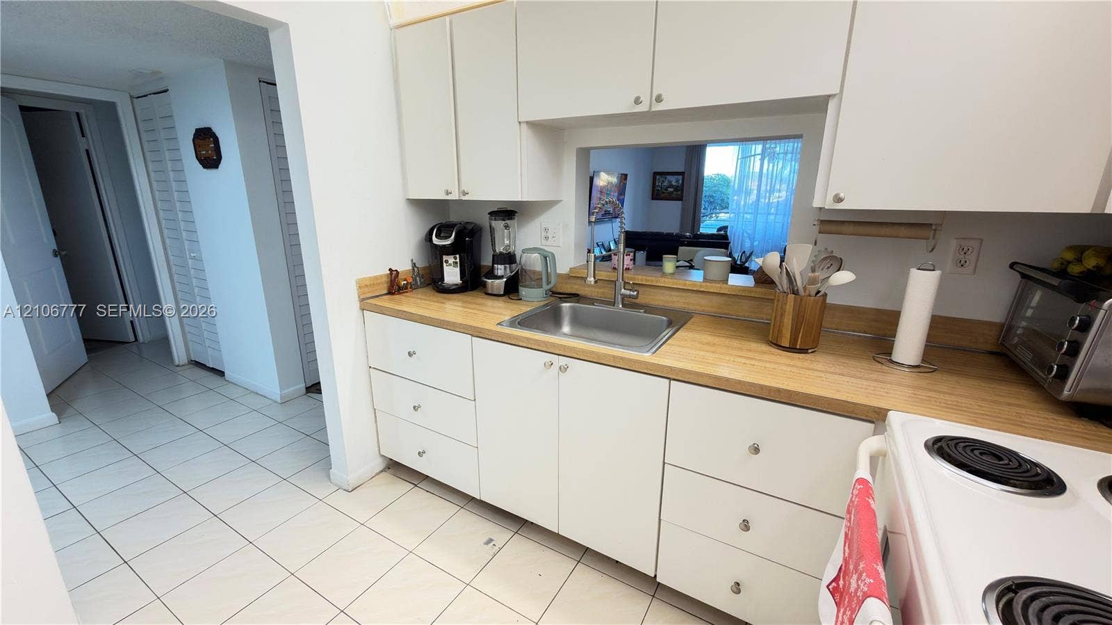 1810 SW 81st Avenue, #2200, North Lauderdale, North Lauderdale, FL 33068 Kitchen featuring white cabinetry, light-toned countertop, stainless steel sink with a goose-neck faucet, and tile flooring