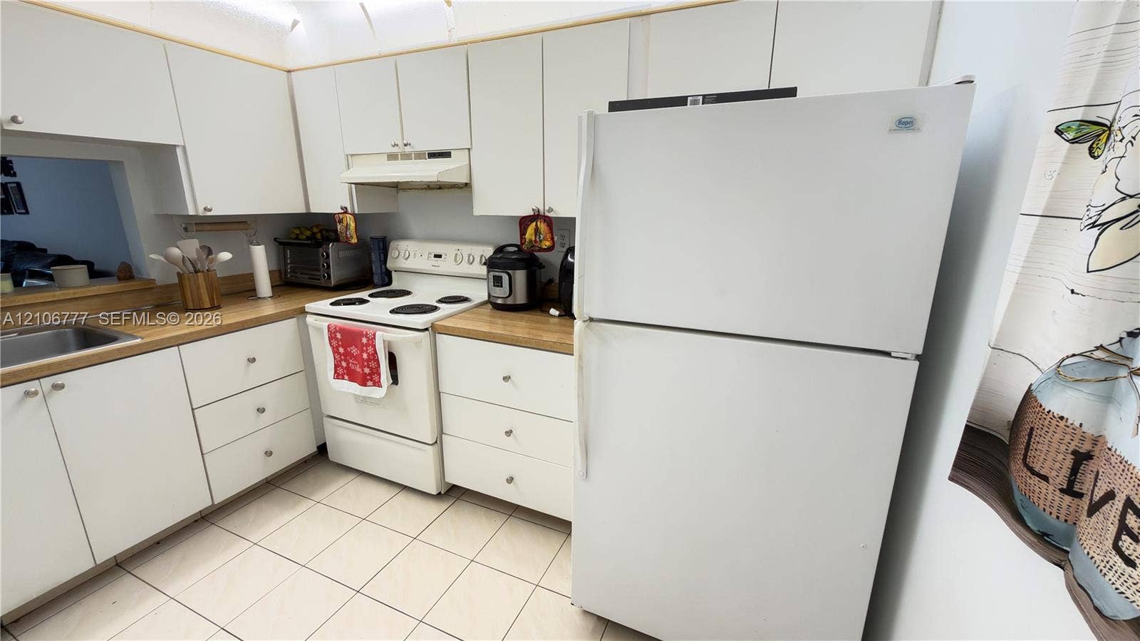 1810 SW 81st Avenue, #2200, North Lauderdale, North Lauderdale, FL 33068 Kitchen featuring white cabinetry, wood-finish countertops, tile flooring, and a range with a built-in hood